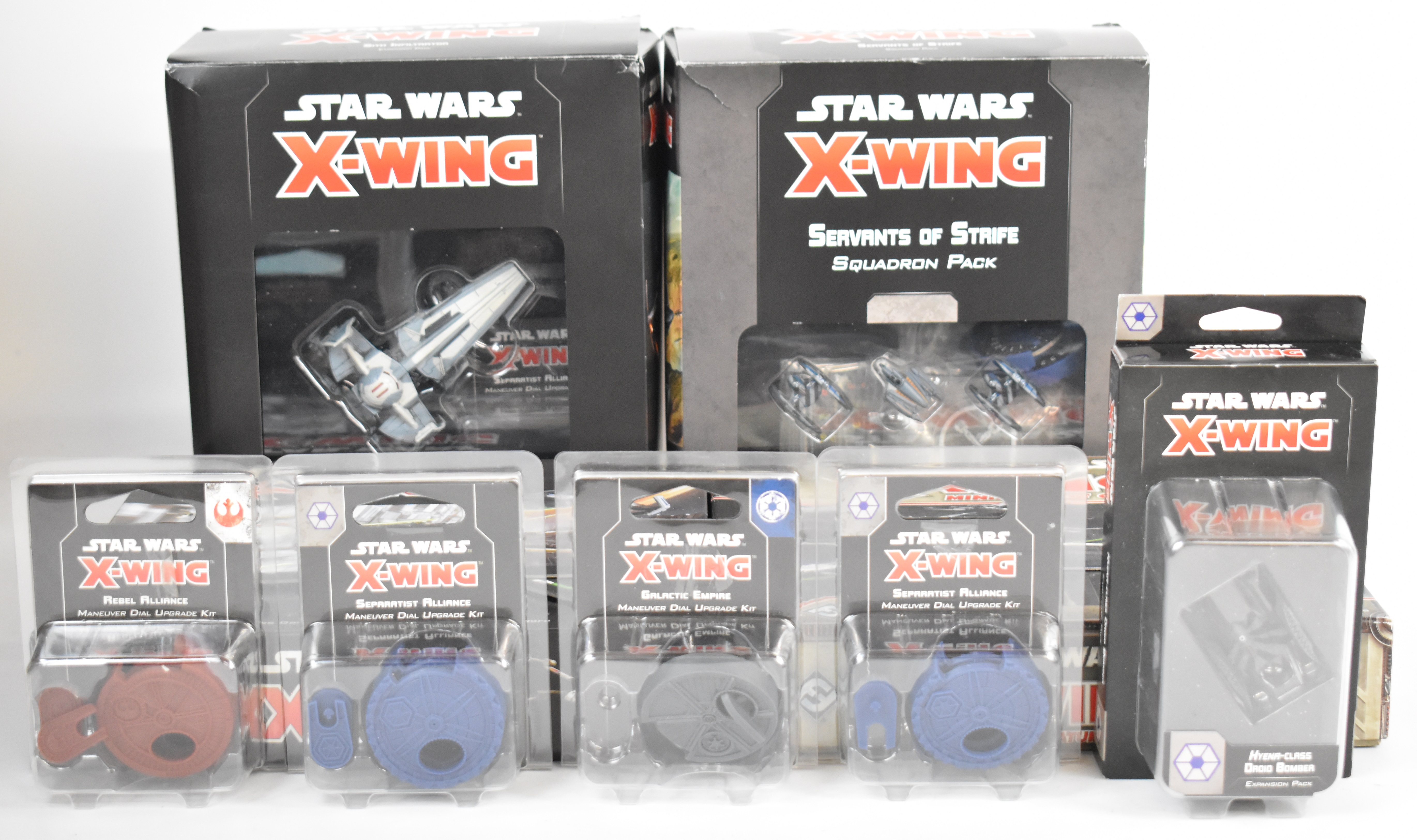 A collection of Star Wars X-Wing wargaming miniatures comprising two core base sets, Servants of