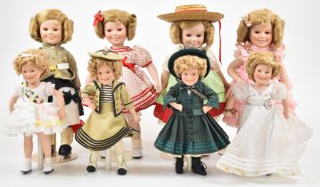 Eight MBI and Danbury Mint Shirley Temple dolls on stands, including Wee Willy Winky and Heidi,