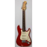 Squire Mini Stratocaster ¾ size electric guitar by Fender, with 20 frets and red finish, serial