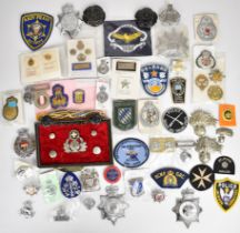 Collection of approximately 50 British and overseas Police cloth / metal badges including Italy