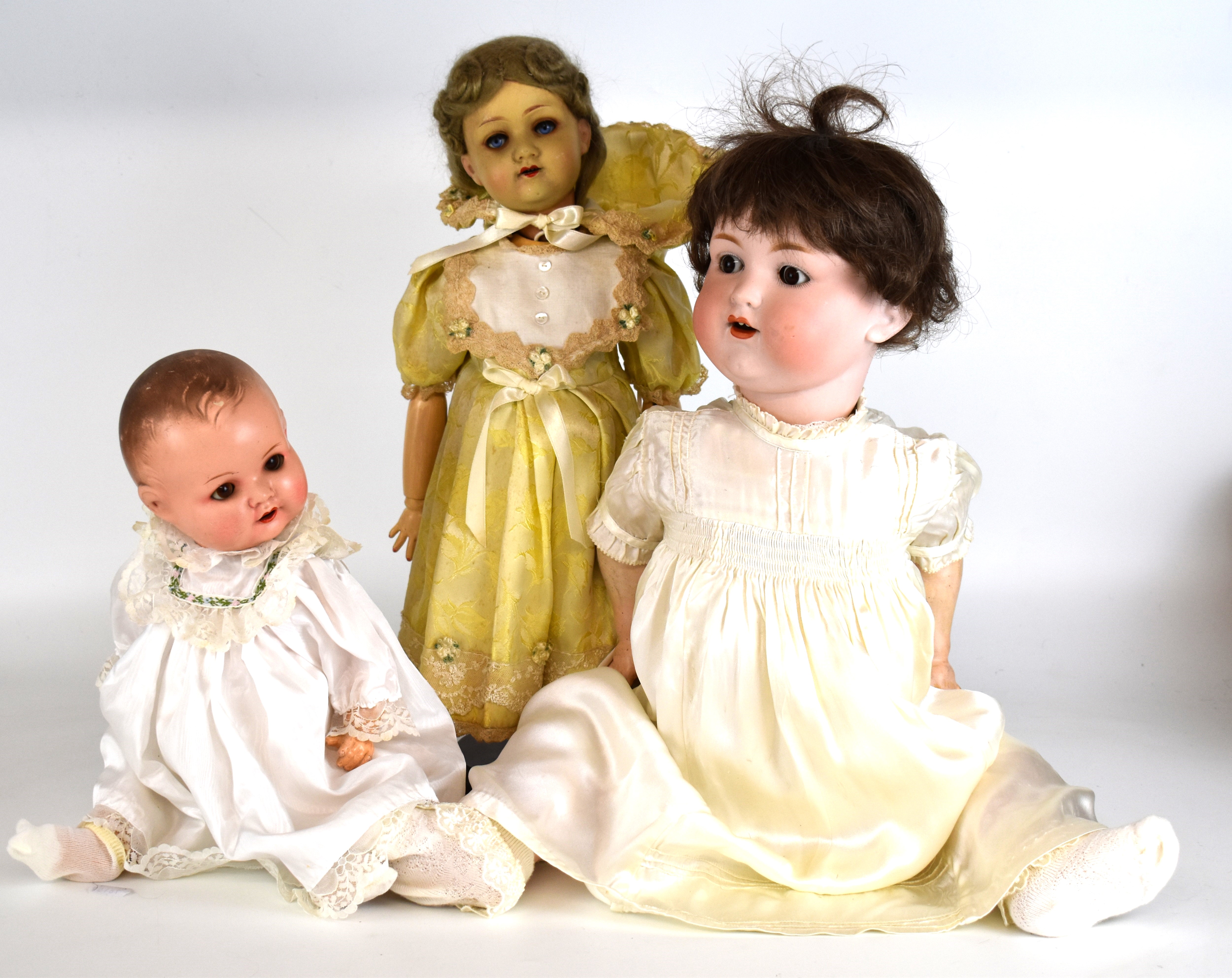 Three Armand Marseille bisque headed dolls with weighted eyes, articulated limbs, painted features