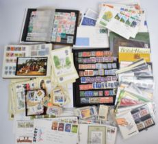 A collection of GB and world stamps in three stock albums, and GB presentation packs and first day