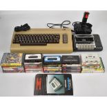 Commodore 64 retro gaming system together with power supply, cassette deck, joystick and a