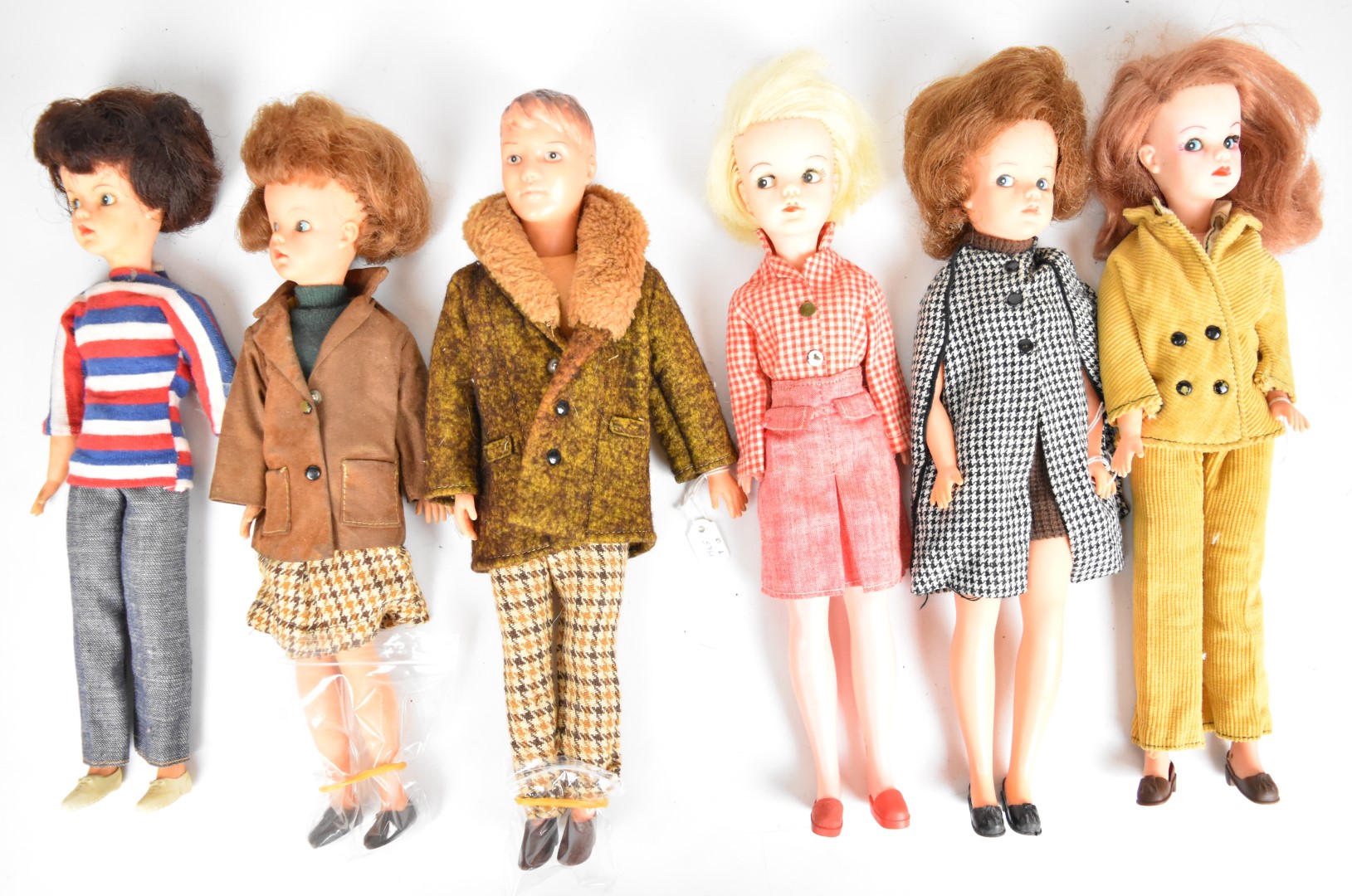 Six vintage Sindy and Paul dolls by Pedigree dressed in original 1960's outfits to include