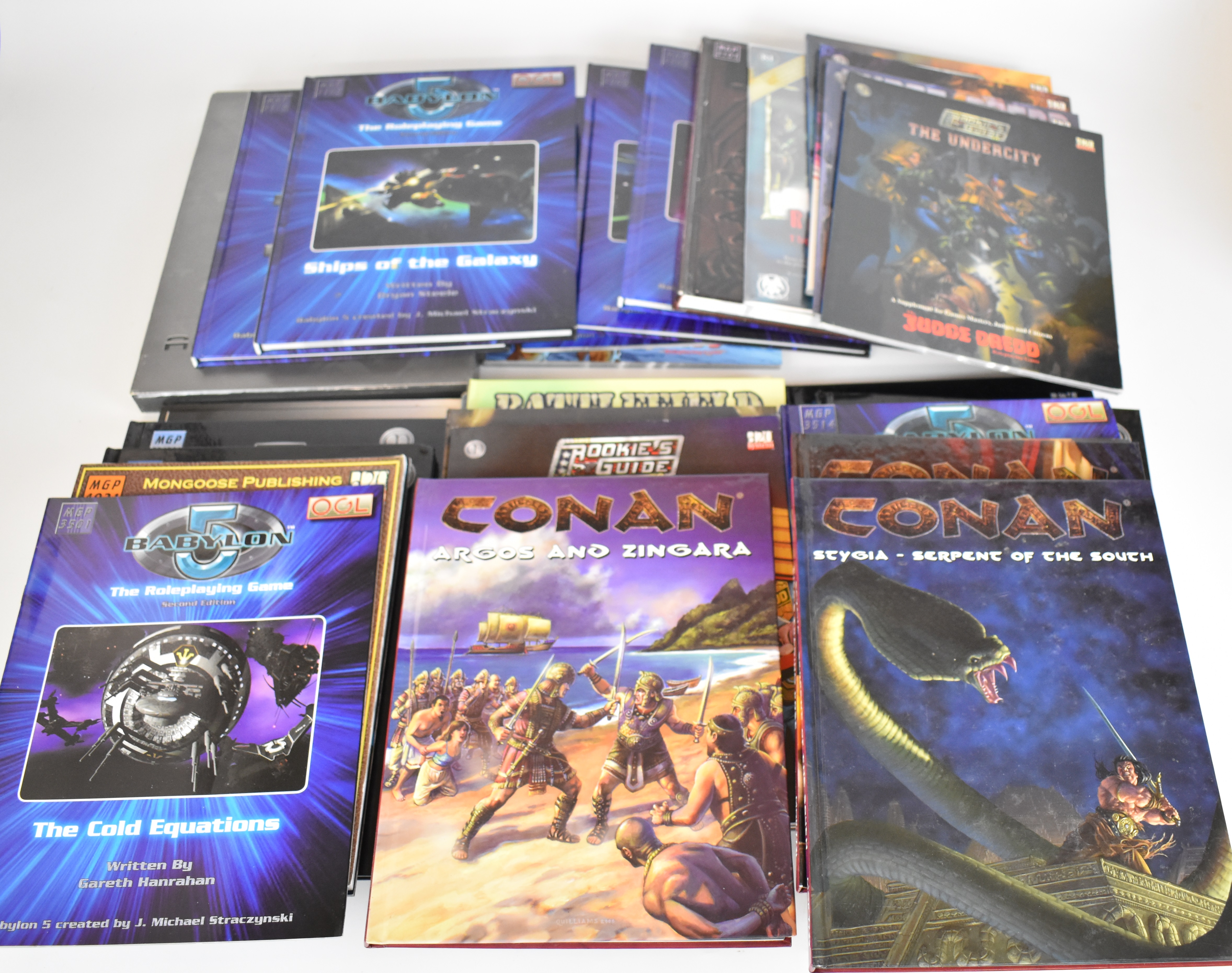 Thirty-three roleplaying game rule books and supplements to include Babylon 5, Judge Dredd,