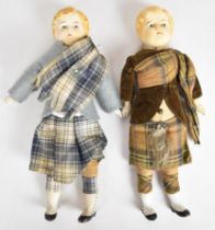 Two small Victorian dolls in traditional Scottish dress, each with a cloth body, ceramic head/