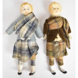 Two small Victorian dolls in traditional Scottish dress, each with a cloth body, ceramic head/