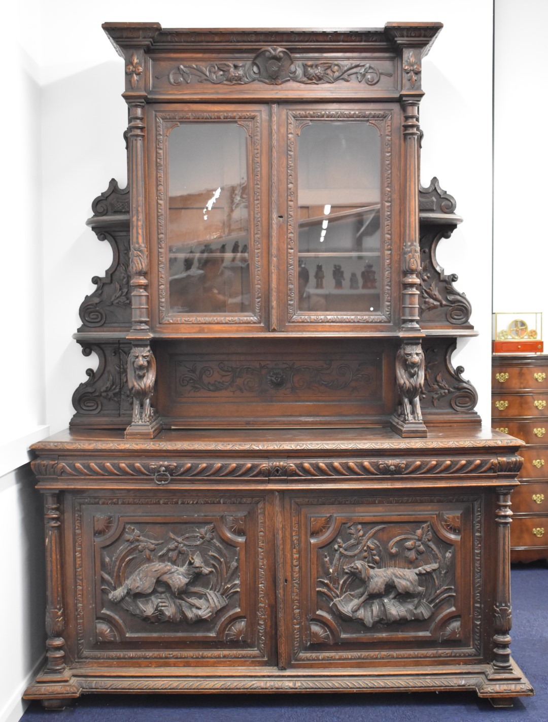 Victorian breakfront carved oak glazed bookcase over two drawers and twin cupboard with hunting