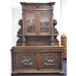 Victorian breakfront carved oak glazed bookcase over two drawers and twin cupboard with hunting