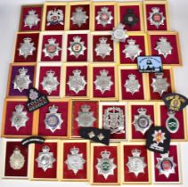 Approximately 250 Police badges, helmet plates and cloth insignia including Royal Ulster