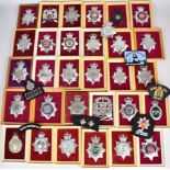 Approximately 250 Police badges, helmet plates and cloth insignia including Royal Ulster