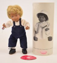 Gotz Sasha Baby Felix doll with articulated limbs, blonde hair, painted features, dungarees and