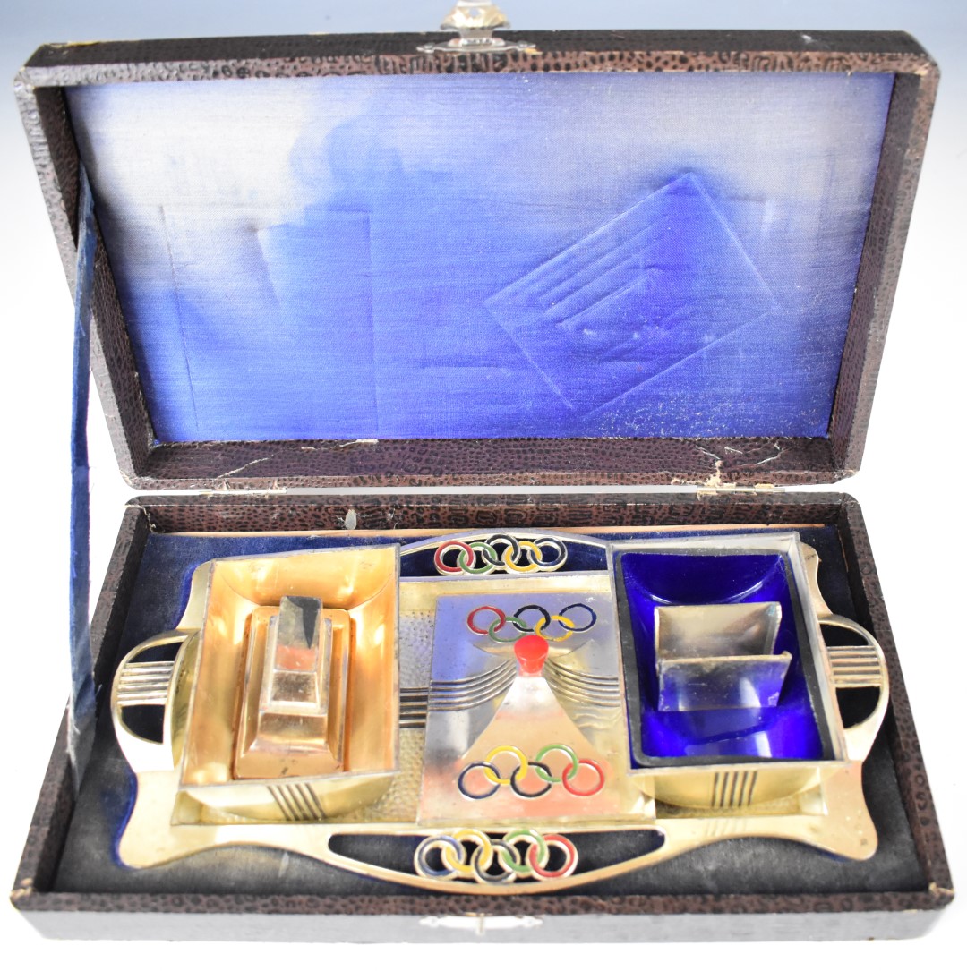 Olympics interest cased silver plated four piece desk set, each piece decorated with the Olympic