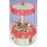 Tinplate clockwork musical carousel with green painted base, canopy, turned wooden figures, fabric