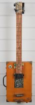 Novelty three string 'cigar box' style electric guitar, 17 frets, length 81cm.