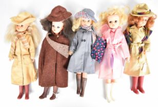 Five vintage Sindy dolls by Pedigree dressed in 1980's Autumnal outfits including hats, scarves,