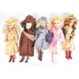 Five vintage Sindy dolls by Pedigree dressed in 1980's Autumnal outfits including hats, scarves,