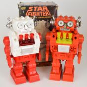 Two battery operated plastic body 'Star Fighter' robots by New Bright (Hong Kong), height 25cm,