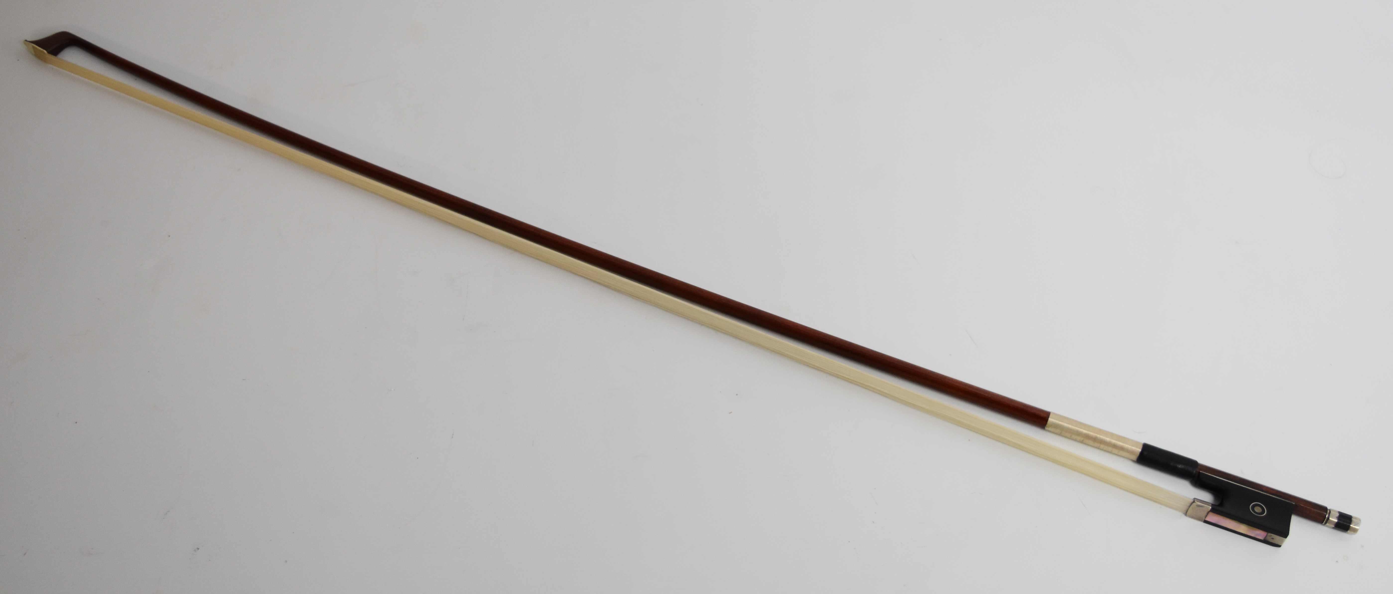 Pernambuco violin bow with ebony frog, faux ivory tip, mother of pearl inlay and silver fittings,