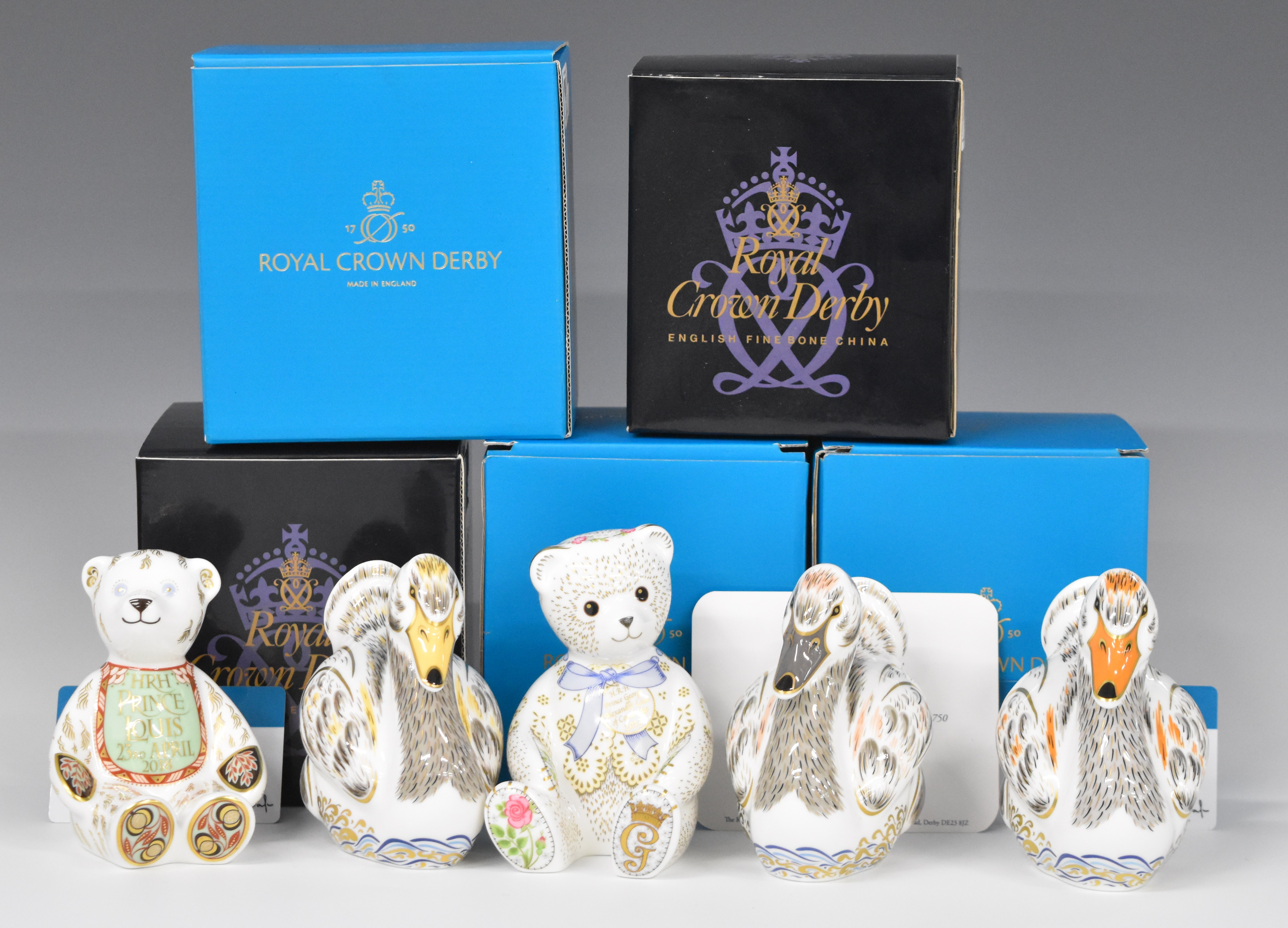 Five Royal Crown Derby Royalty related paperweights comprising Royal Cygnets, George, Charlotte,