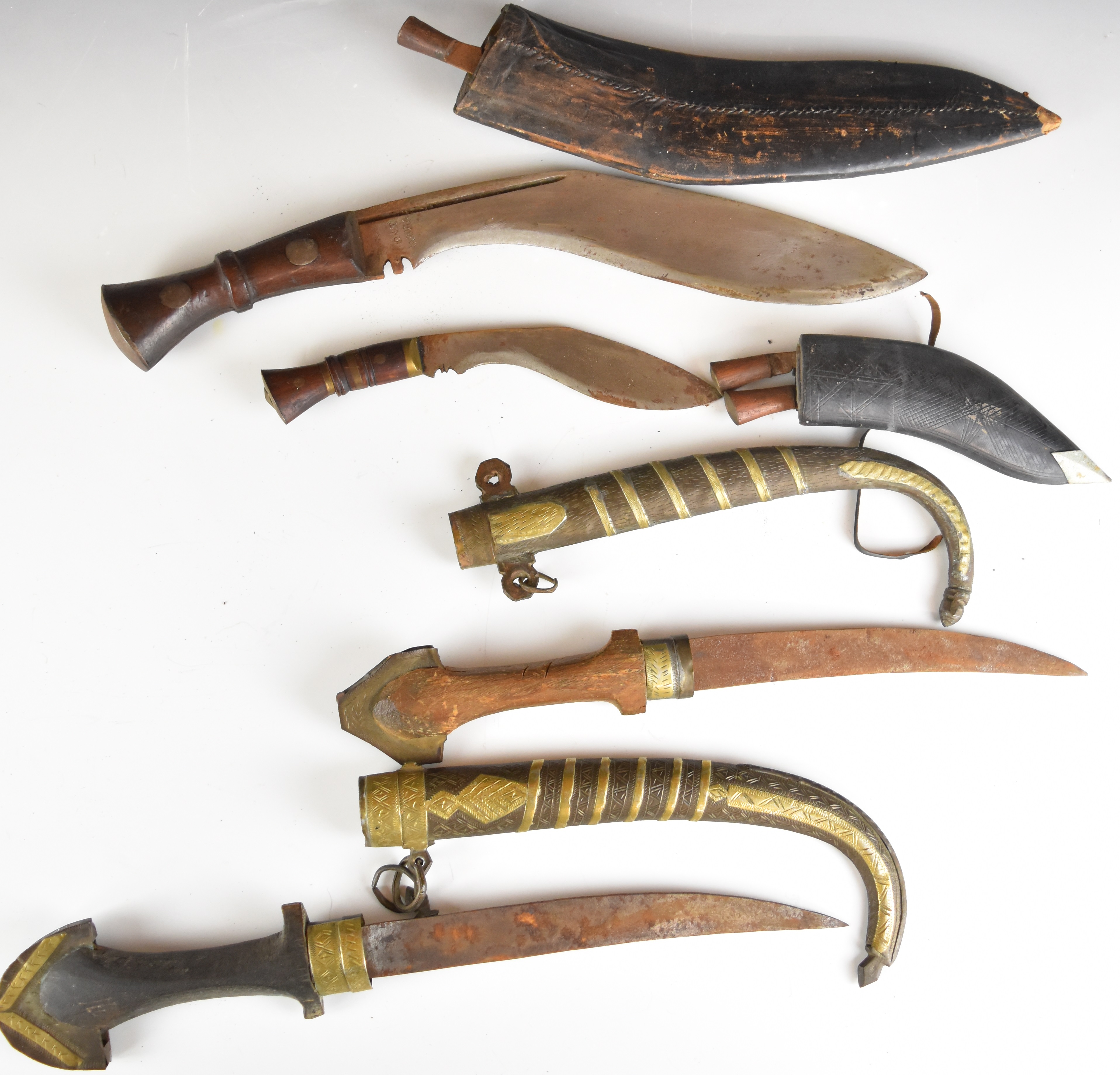 Two kukri knives both with wooden handles, longest blade 30cm, together with two Jambiya knives of