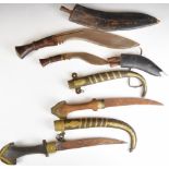 Two kukri knives both with wooden handles, longest blade 30cm, together with two Jambiya knives of