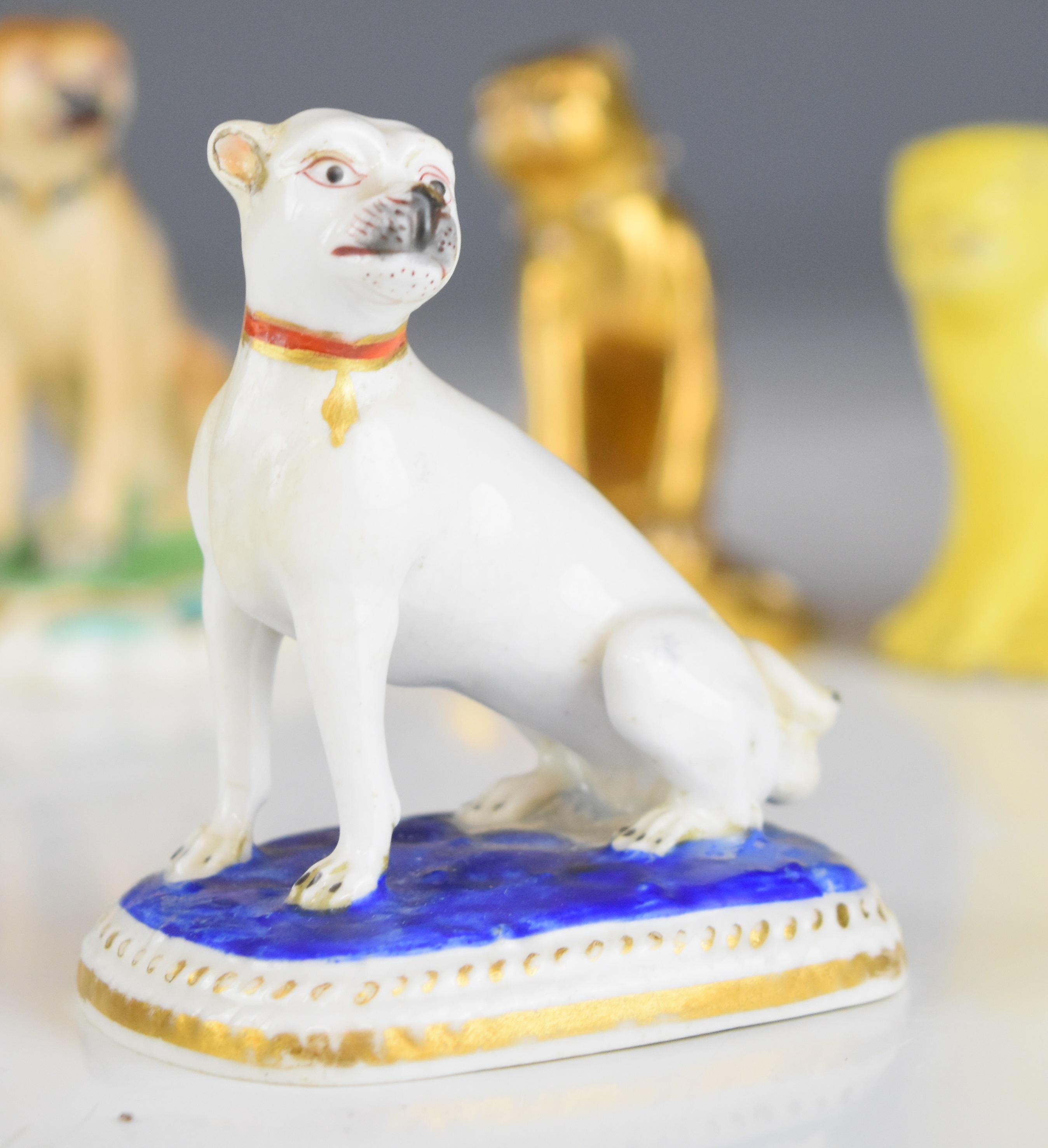 Collection of 19thC miniature porcelain / pottery pug figures including Crown Derby, tan example - Image 9 of 14