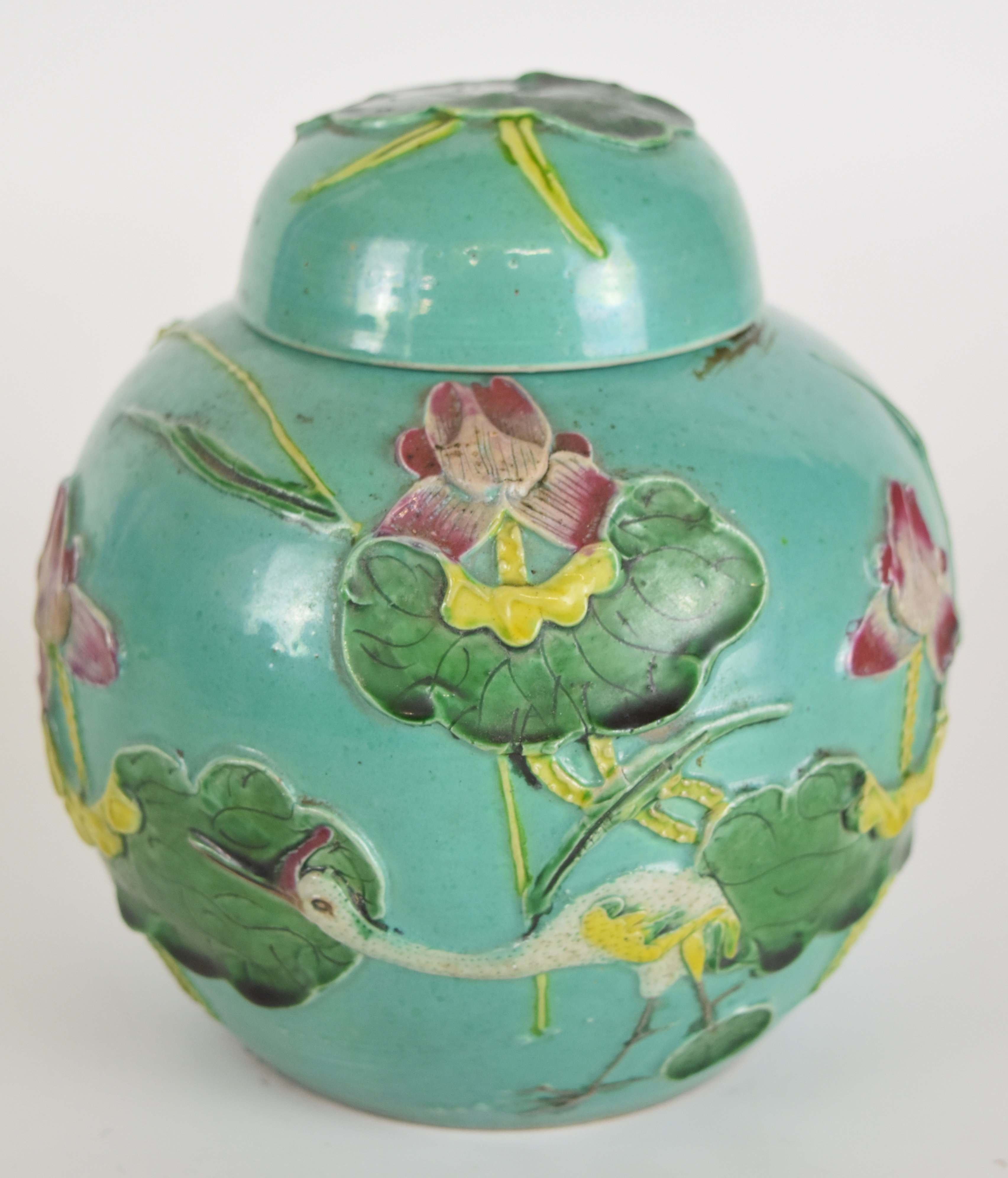 Chinese Sancai pottery ginger jar with relief decoration of birds and water lilies on a turquoise