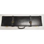 Black leather shotgun case with fitted interior and code locks, 82.5 x 21 x 11cm.