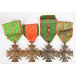 Four French WW1 Croix De Guerre Medals, one with palm leaves and one with a star