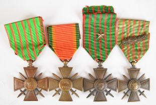 Four French WW1 Croix De Guerre Medals, one with palm leaves and one with a star