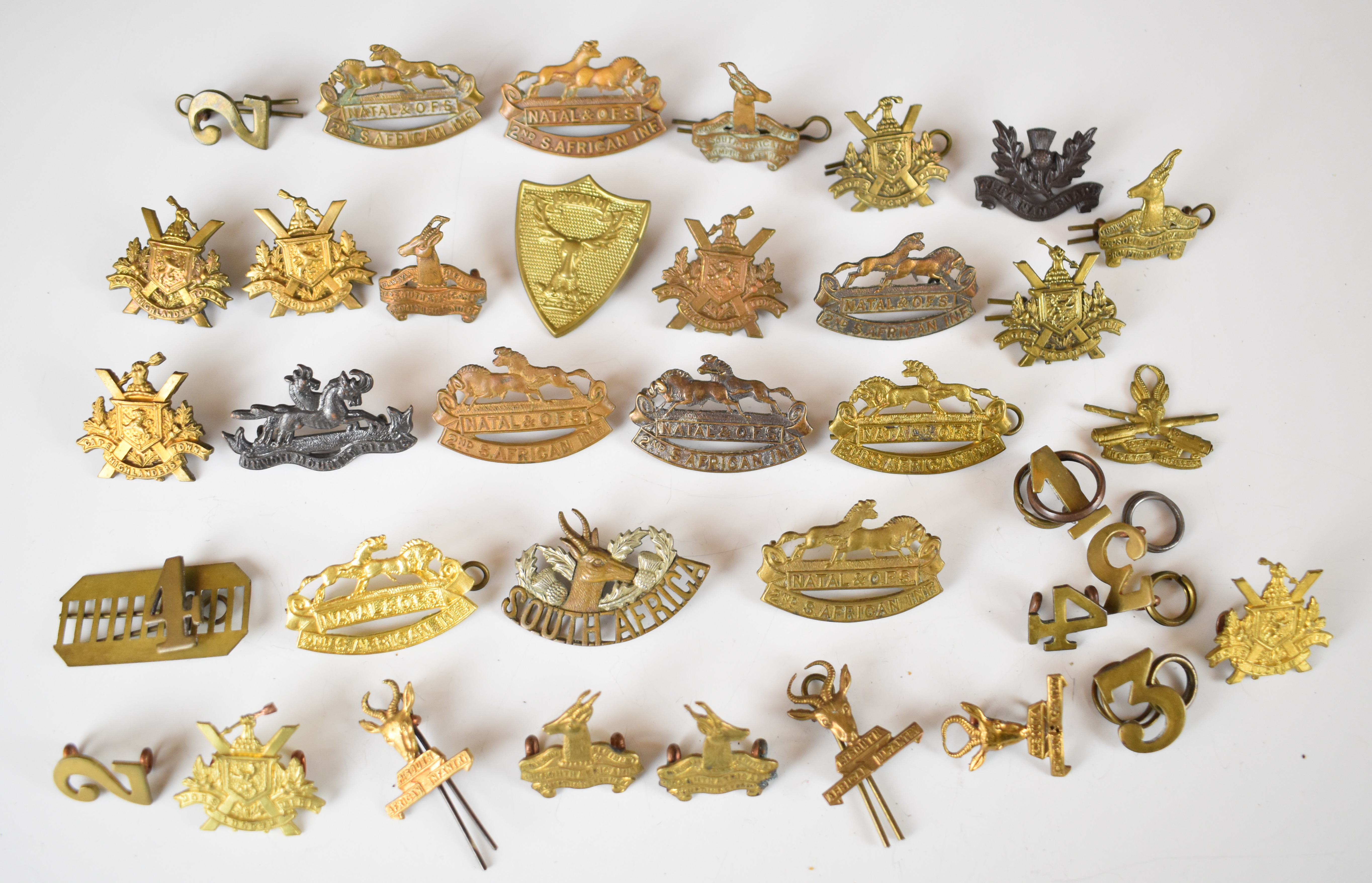 Approximately 20 South African collar badges including 2nd South African Infantry, one with G&S