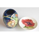 Moorcroft vase decorated in the Queen's Choice pattern and a pin dish decorated in the Hibiscus