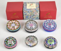 Six millefiori glass paperweights including Perthshire and Peter McDougal examples, some in original