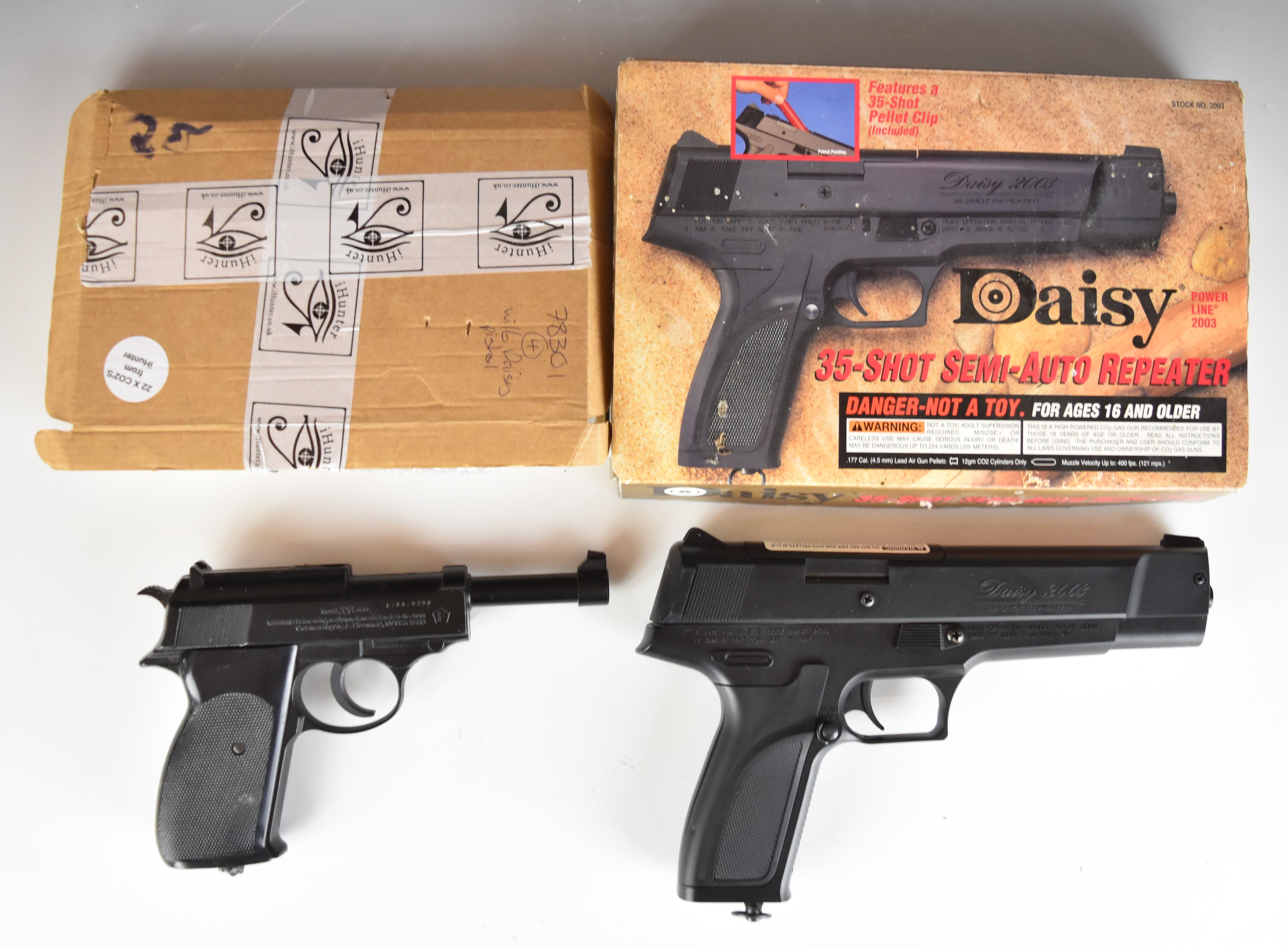 Two CO2 air pistols Daisy Model 2003 35-shot repeater .177 with chequered composite grips and