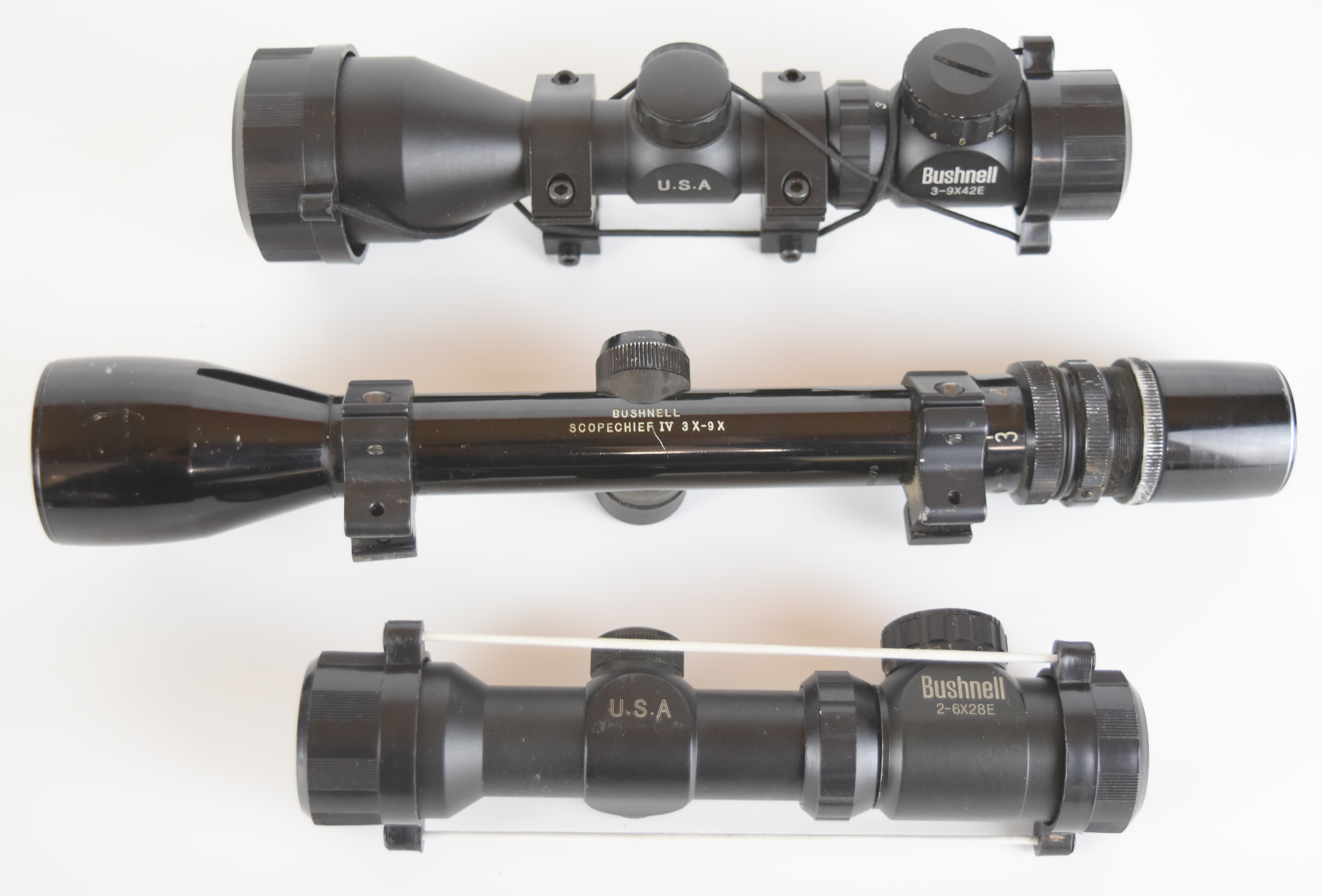 Three Bushnell rifle scopes Scopechief IV 3x-9x, 3-9x42E and 2-6x28E.