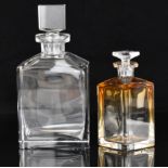 Two glass decanters, one Moser with graduated amber to clear design, signed to base, the other of