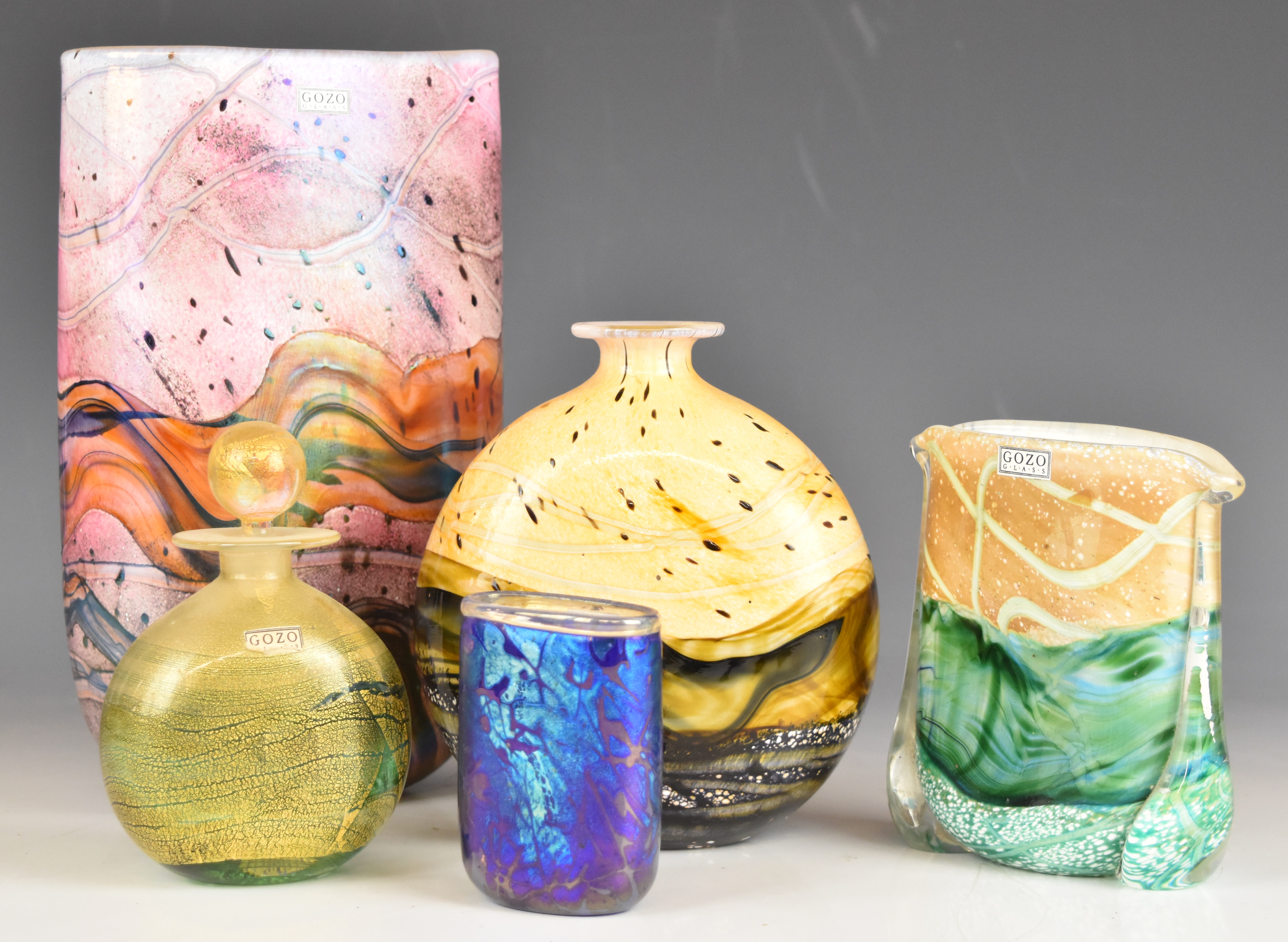 Five pieces of Gozo glass comprising four vases and a scent bottle, some with iridescent