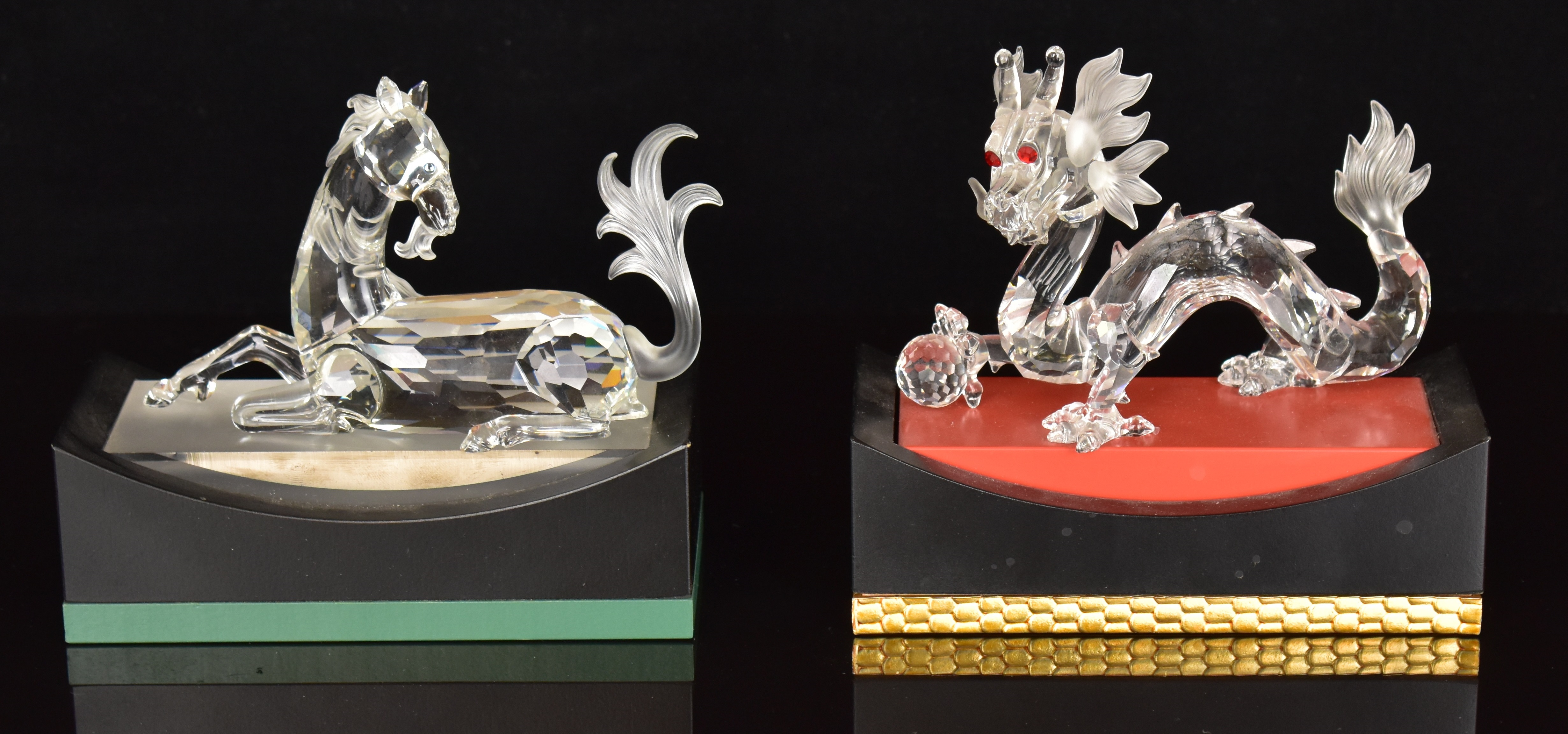 Swarovski Crystal glass dragon and unicorn, both on display plinths, each base 15cm long.