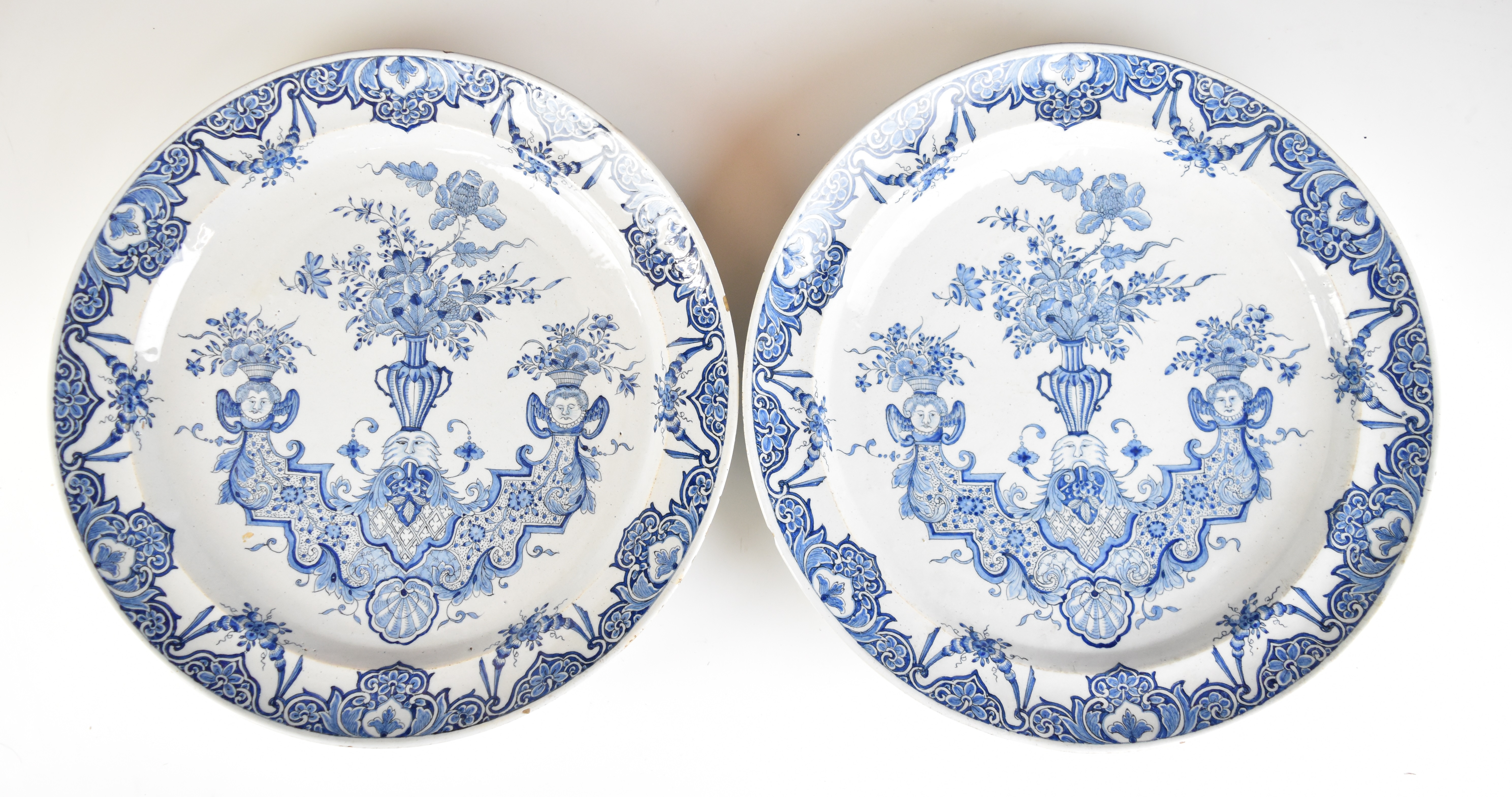 A pair of 19thC Delft chargers with figural urn decoration, diameter 33cm
