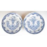 A pair of 19thC Delft chargers with figural urn decoration, diameter 33cm