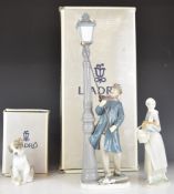 Lladro figures comprising 'The Lamplighter', girl with hen and a puppy figure 'New Friend', two
