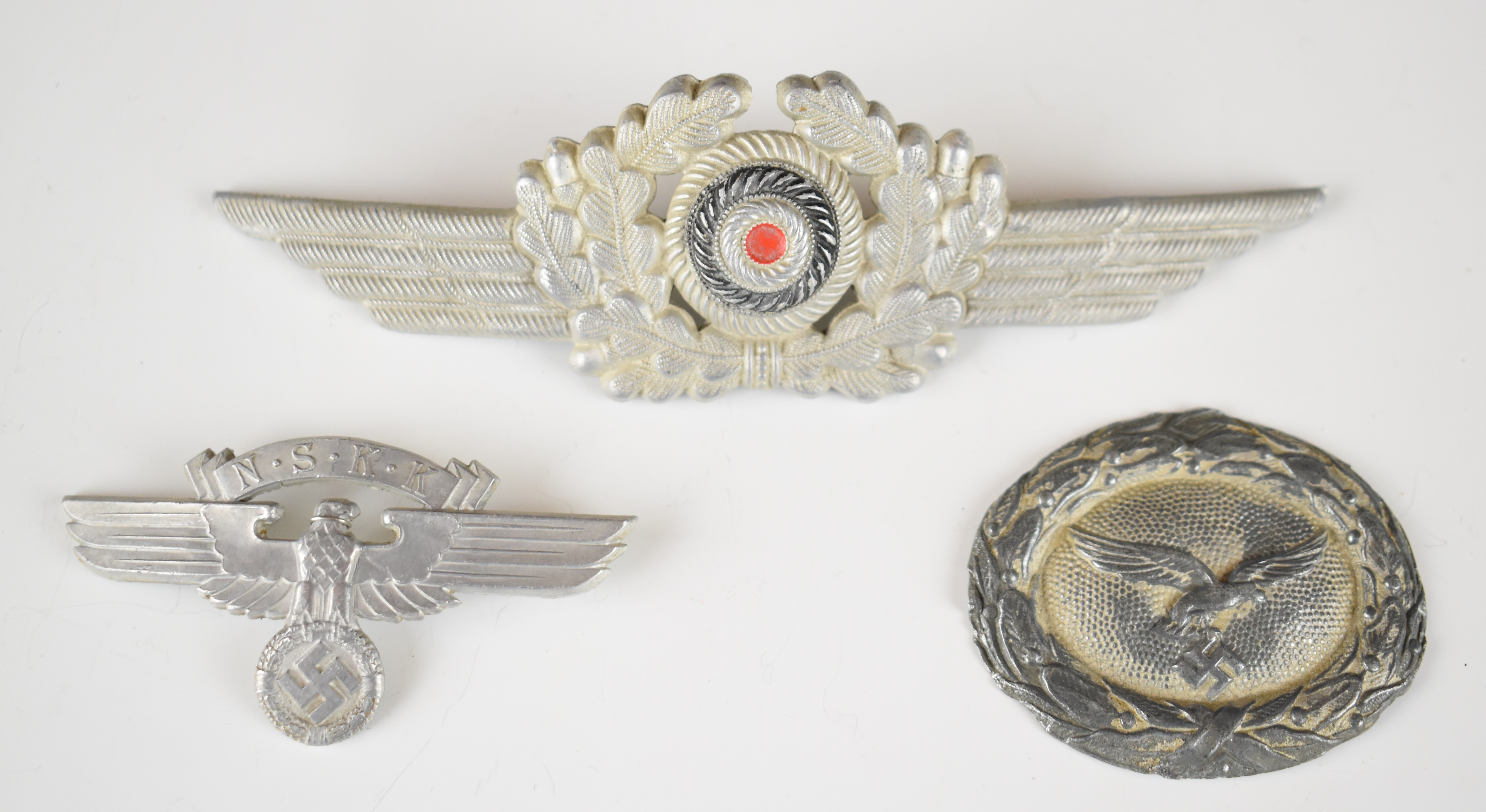Two German WW2 Nazi Third Reich Luftwaffe badges and a NSKK example