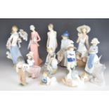 A collection of Lladro and Nao figurines and an advertising stand, tallest 32cm