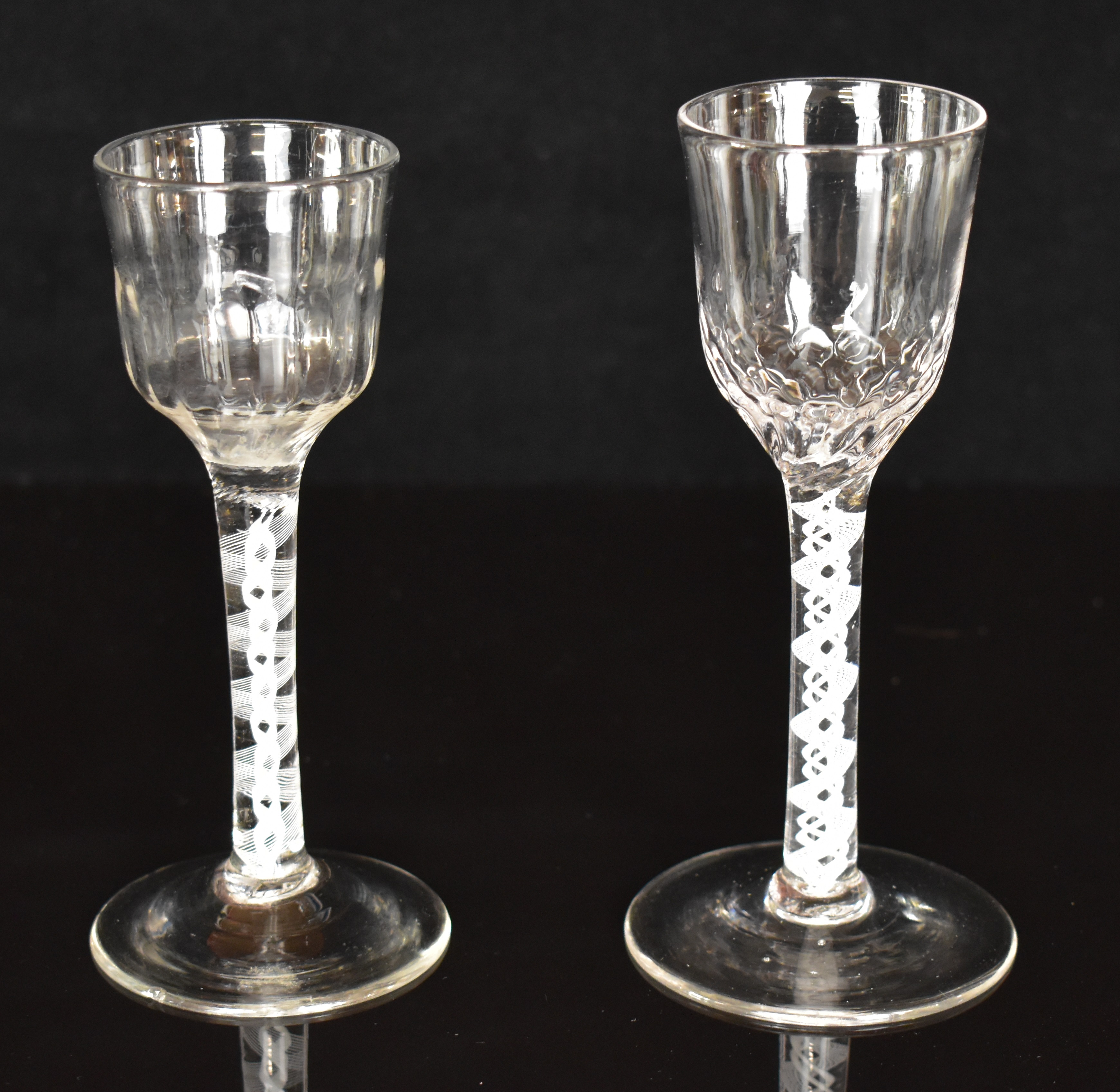 Two Georgian drinking glasses each with cotton twist stem and twisted bowl, largest 15cm tall.
