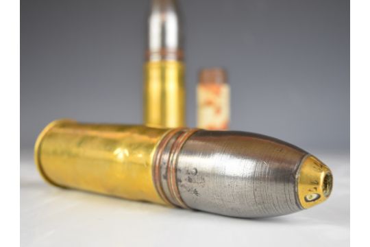 Three brass shells, all with projectiles, tallest 26cm and a steel plug with label 'steel plug - Image 4 of 9