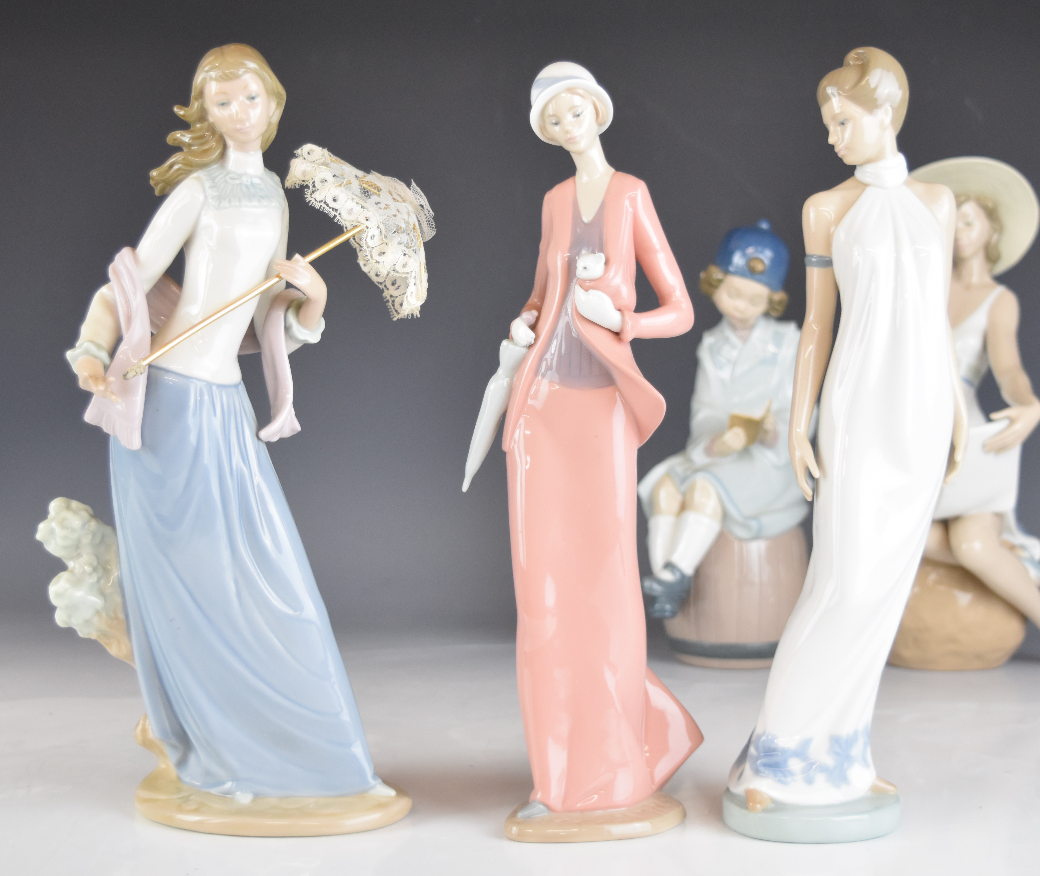 A collection of Lladro and Nao figurines and an advertising stand, tallest 32cm - Image 12 of 14