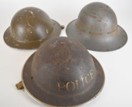 WW2 British 'Brodie' steel helmet marked Police together with another similar example stamped to the