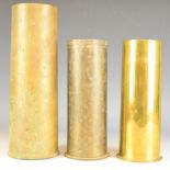 Three brass shell cases comprising one dated 1918, another 1917 decorated and etched Peronne and the
