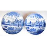 A pair of 18th/ 19thC Delft chargers or shallow bowls with decoration of figures in parkland with